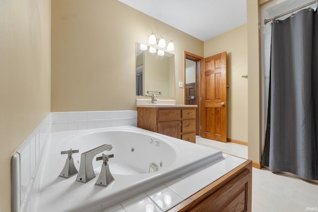 bathroom featuring vanity and tiled tub