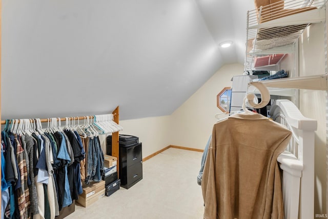 walk in closet featuring lofted ceiling and carpet flooring