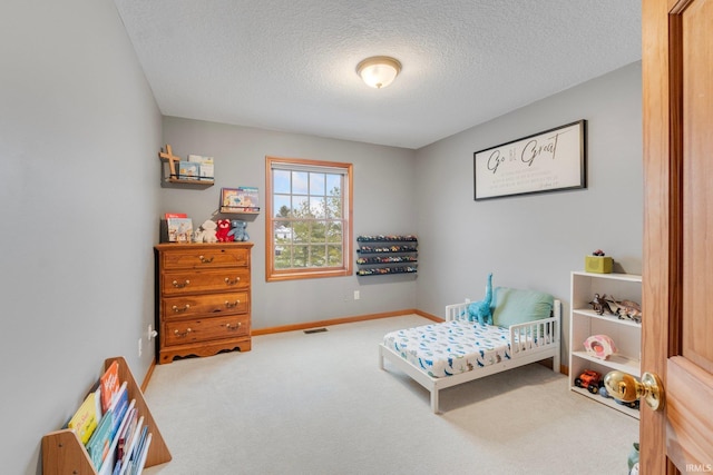 bedroom with carpet and a textured ceiling