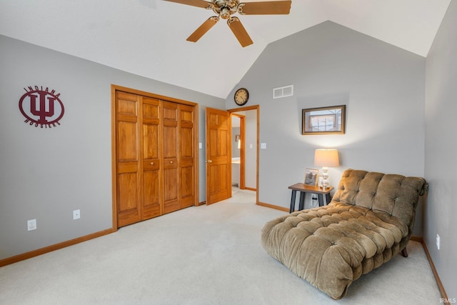 living area featuring lofted ceiling, carpet flooring, and ceiling fan