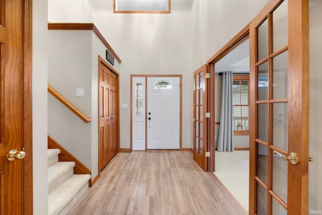 foyer with french doors and light hardwood / wood-style flooring