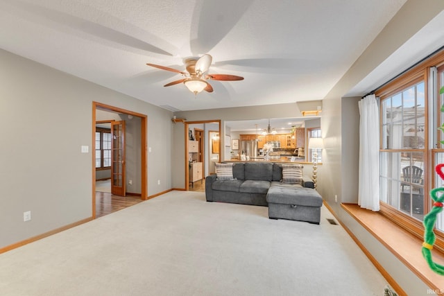 living room featuring carpet and ceiling fan