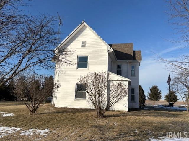 view of property exterior with a yard