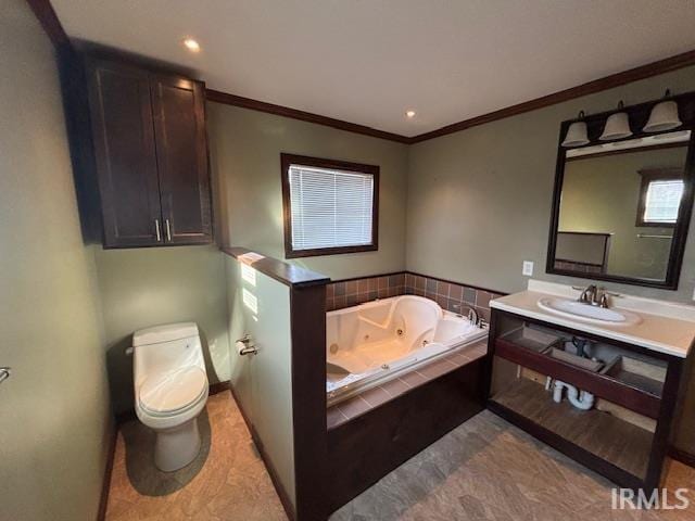 bathroom featuring vanity, ornamental molding, tiled bath, and toilet