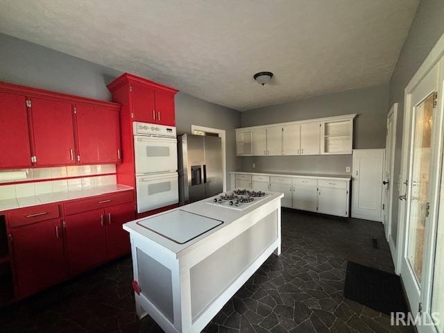 kitchen with stainless steel appliances and a textured ceiling