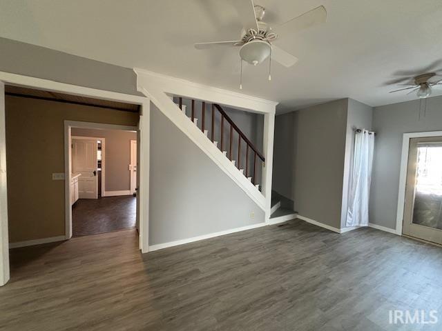 interior space featuring dark hardwood / wood-style flooring and ceiling fan