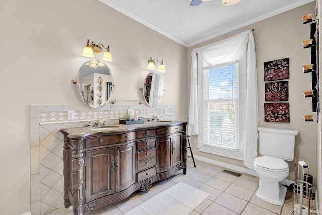 bathroom featuring crown molding, vanity, a textured ceiling, tile patterned floors, and toilet