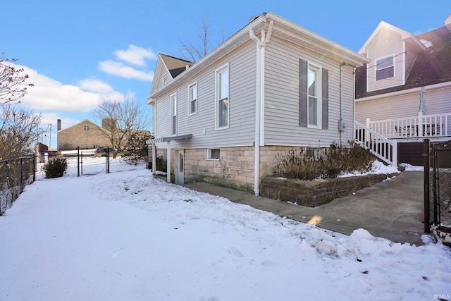 snow covered property featuring fence