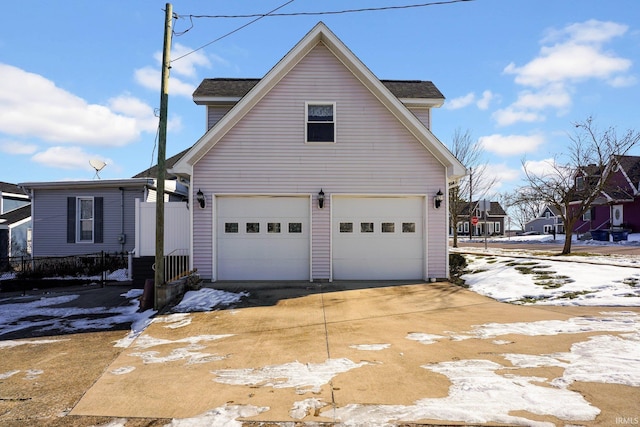 snow covered property featuring a garage