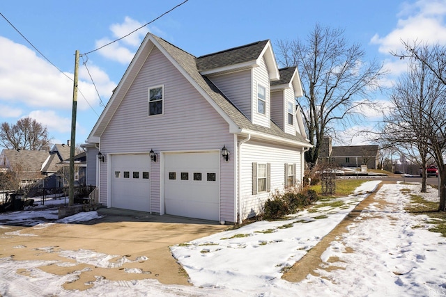 snow covered property featuring a garage