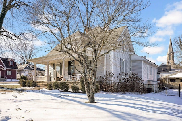 view of front of property with covered porch and fence