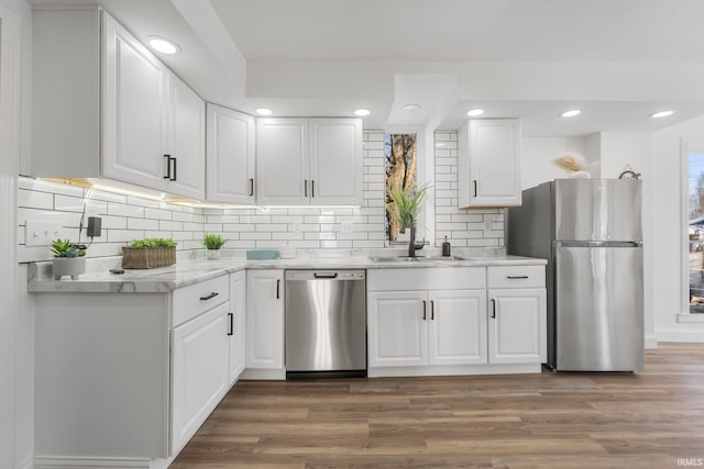 kitchen featuring stainless steel appliances, sink, white cabinets, and dark hardwood / wood-style flooring