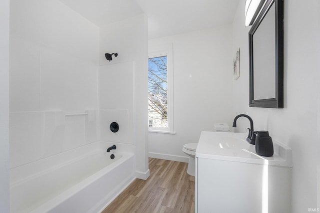 full bathroom featuring vanity, bathtub / shower combination, hardwood / wood-style floors, and toilet