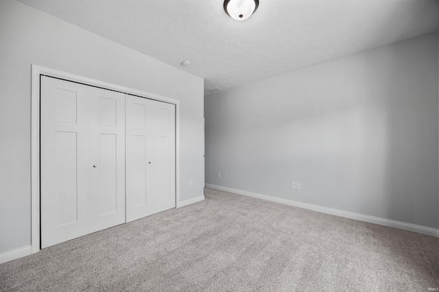 unfurnished bedroom with carpet floors and a closet