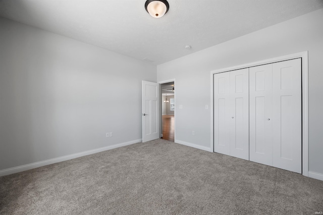 unfurnished bedroom with a closet and carpet