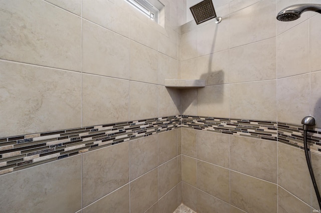 interior details featuring a tile shower