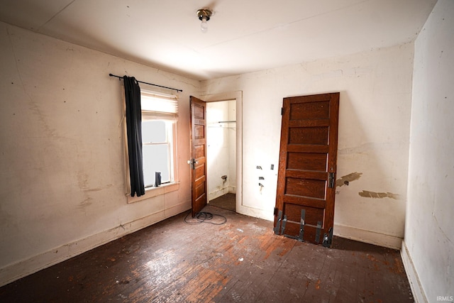 unfurnished bedroom featuring dark wood-type flooring