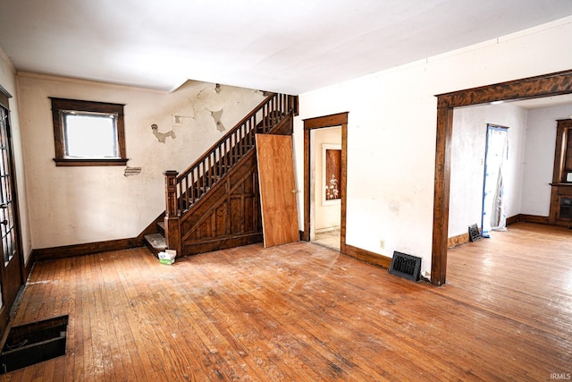 unfurnished living room featuring wood-type flooring