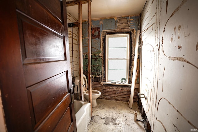 bathroom featuring toilet and a bath