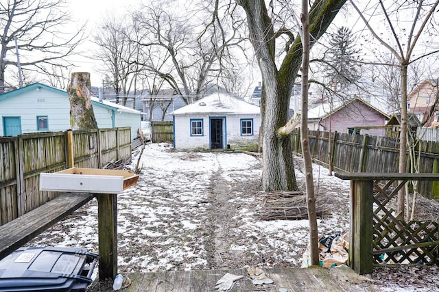 snowy yard featuring an outdoor structure