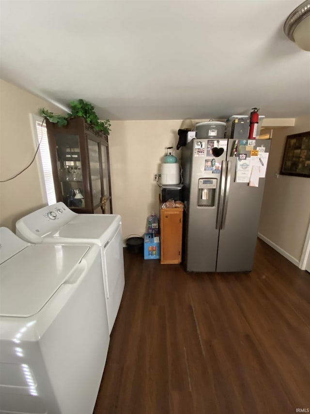 laundry room with independent washer and dryer and dark hardwood / wood-style flooring