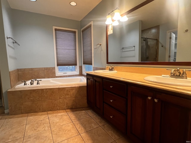 bathroom with tile patterned flooring, vanity, and separate shower and tub