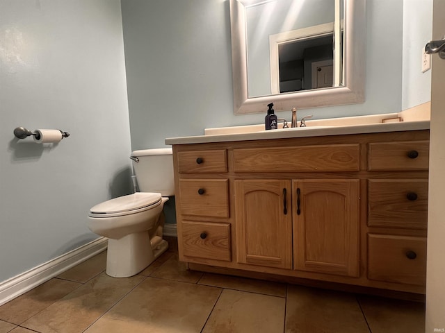 bathroom with vanity, toilet, and tile patterned flooring