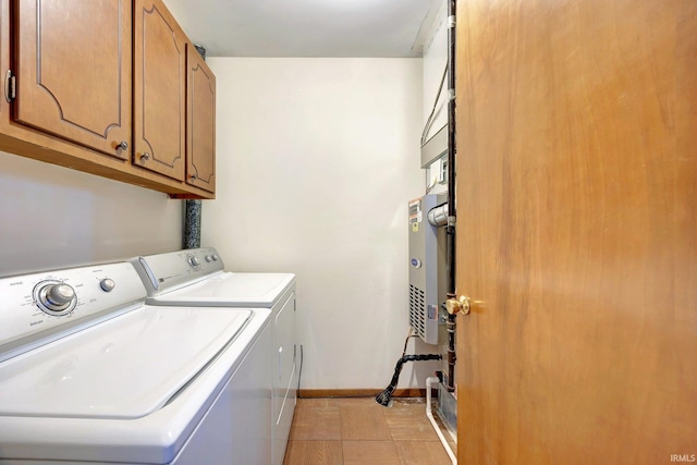 clothes washing area featuring washer and clothes dryer and cabinets