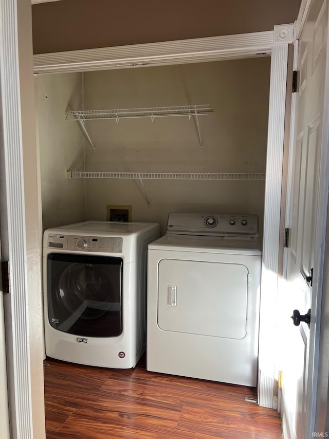 washroom featuring dark hardwood / wood-style flooring and independent washer and dryer