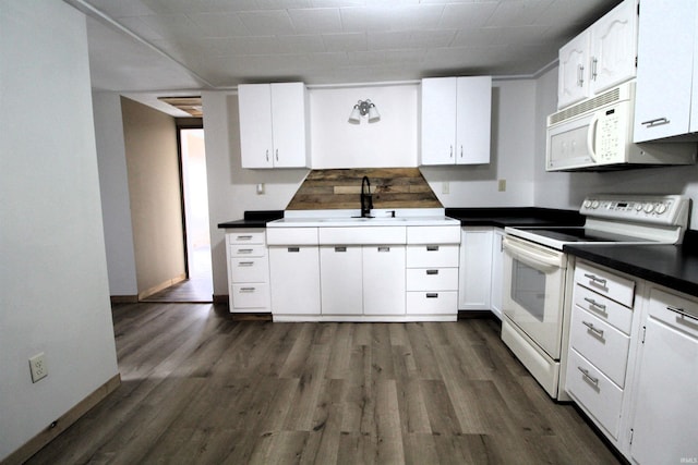 kitchen featuring dark hardwood / wood-style flooring, sink, white appliances, and white cabinets