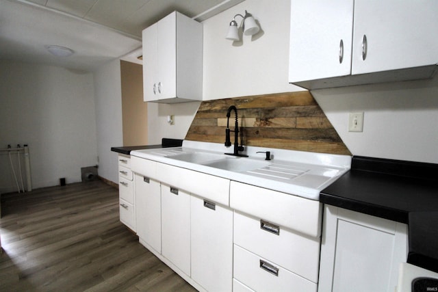 kitchen with sink, dark wood-type flooring, and white cabinets