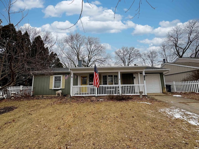 single story home featuring a porch, a garage, and a front lawn