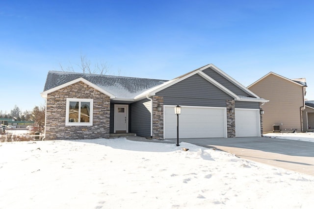 view of front of house with central AC unit and a garage