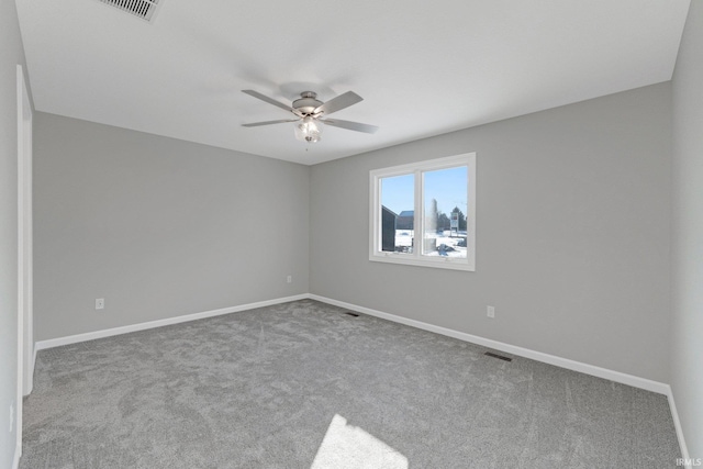 spare room featuring light colored carpet and ceiling fan