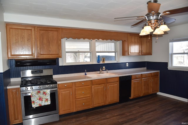 kitchen with sink, dishwasher, range hood, dark hardwood / wood-style floors, and stainless steel gas range oven