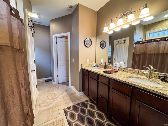 bathroom with vanity, tile patterned floors, and walk in shower