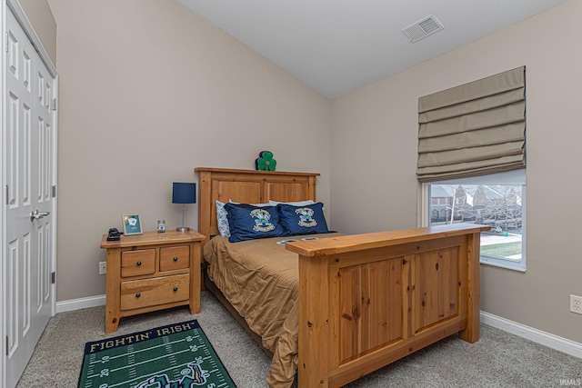 carpeted bedroom featuring lofted ceiling and a closet