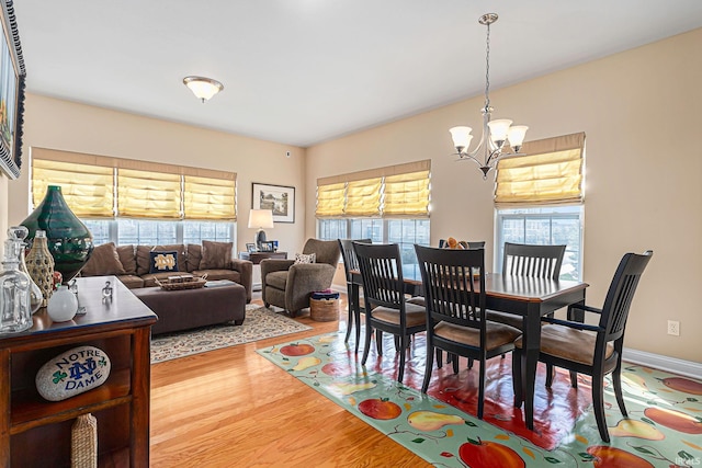 dining area with a notable chandelier and hardwood / wood-style floors