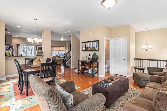 living room with wood-type flooring and a chandelier