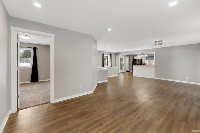 unfurnished living room with dark wood-type flooring