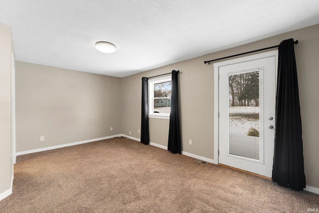 unfurnished bedroom featuring a textured ceiling and carpet flooring