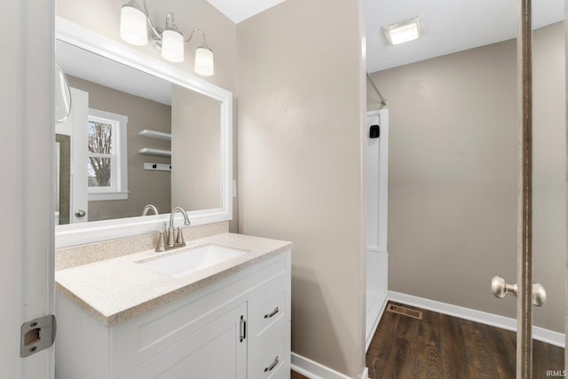 bathroom featuring vanity and hardwood / wood-style floors