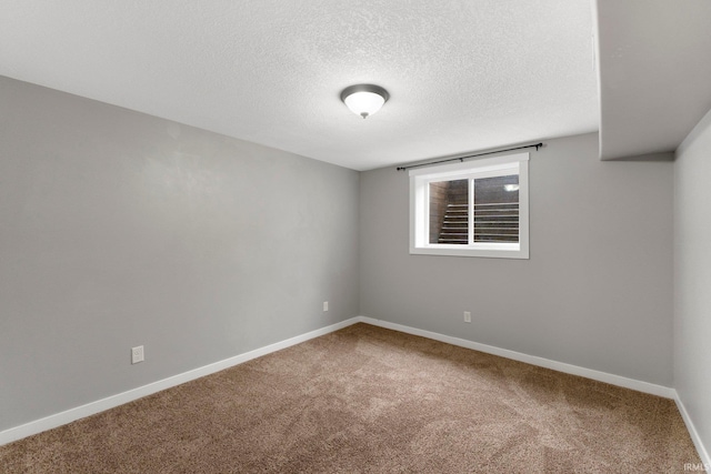 carpeted spare room featuring a textured ceiling