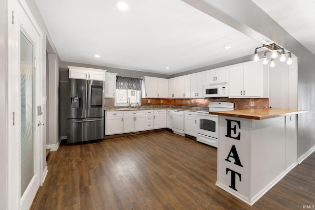 kitchen featuring butcher block countertops, white appliances, sink, white cabinetry, and decorative backsplash