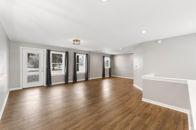 empty room with dark hardwood / wood-style flooring