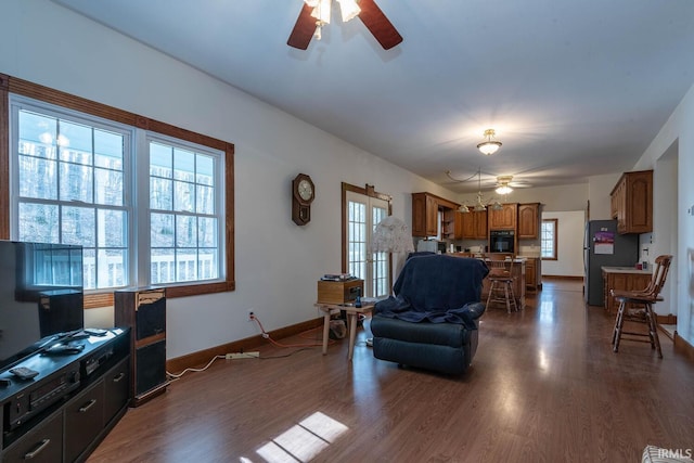 living room with ceiling fan, a healthy amount of sunlight, and dark hardwood / wood-style floors