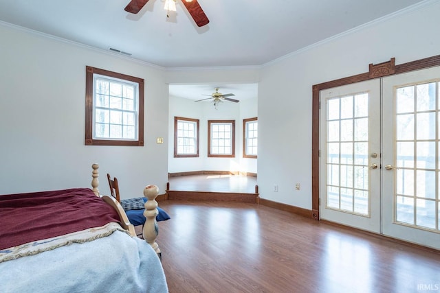 bedroom featuring french doors, hardwood / wood-style flooring, ceiling fan, access to exterior, and multiple windows