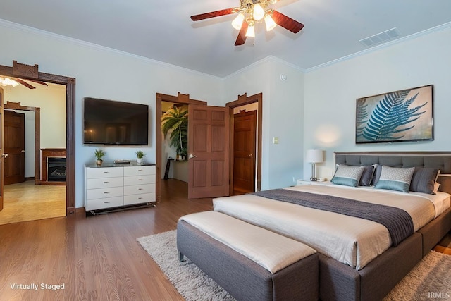 bedroom featuring crown molding, ceiling fan, and hardwood / wood-style flooring