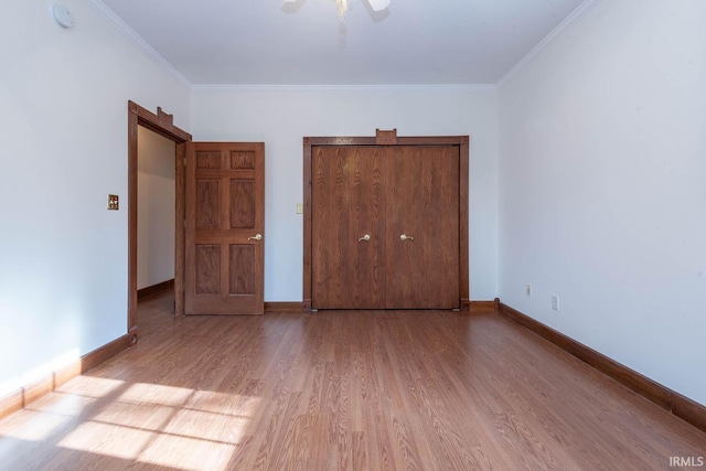 unfurnished bedroom featuring crown molding, ceiling fan, and light wood-type flooring