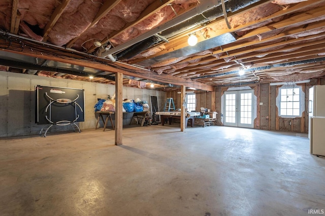 basement featuring white refrigerator and french doors